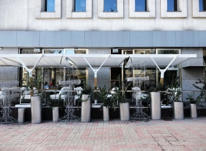 Holy Burger - facade with signage and large windows overlooking the street