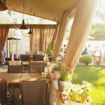 Restaurant Very Well Cafe - outdoor dining terrace featuring modern tables chairs and decorative plants