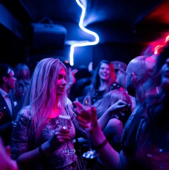 Woman with a glass in a party crowd at Alchemist Bar, Kyiv