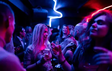 Woman with a glass in a party crowd at Alchemist Bar, Kyiv