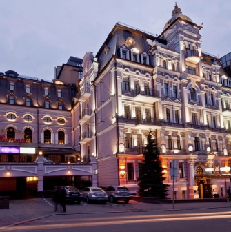 Illuminated facade of the Opera Hotel in Kyiv in the evening