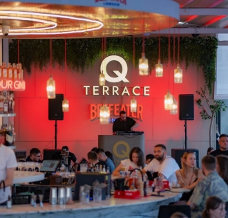 Q Terrace - an indoor dining area with elegant modern furniture and a bar