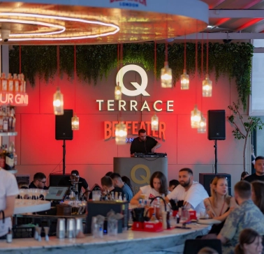 Q Terrace - an indoor dining area with elegant modern furniture and a bar