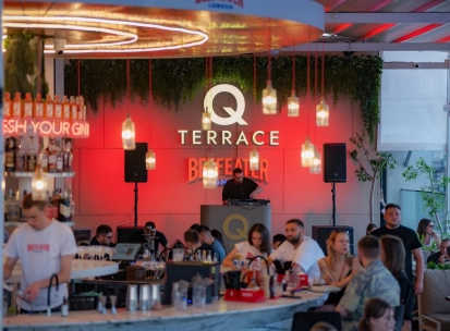 Q Terrace - an indoor dining area with elegant modern furniture and a bar