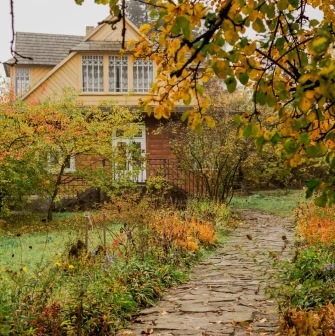 Pyrohiv Museum in Kyiv - rural wooden house surrounded by autumn garden
