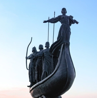 Monument to the Founders of Kyiv - the legendary founders on a boat, overlooking the Dnipro River and cityscape