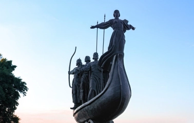 Monument to the Founders of Kyiv - the legendary founders on a boat, overlooking the Dnipro River and cityscape