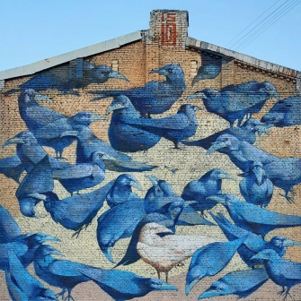 Messenger of Life in Kyiv - mural depicting a white crow symbolizing bright life amidst darkness