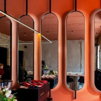 Designer mirror wall decoration at Pure & Naive restaurant in Kyiv with orange interior