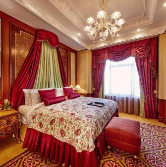 Luxurious room at the Fairmont Grand Hotel in Kyiv with red decoration and classic interior