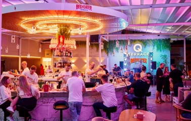 Q Terrace is a long, modern bar with a prominent display of various drinks