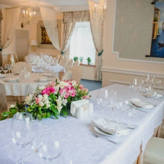 An elegantly set table with flowers in the restaurant of Royal Olympic Hotel in Kyiv