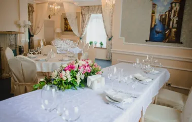 An elegantly set table with flowers in the restaurant of Royal Olympic Hotel in Kyiv