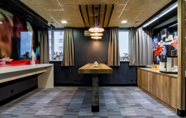 Ibis Railway Station in Kyiv - Break room with wooden table and coffee machine