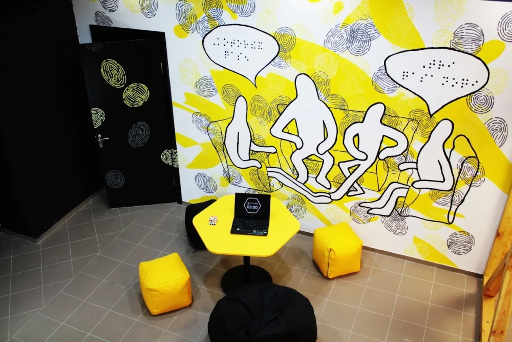Muzei u Temriavi in Kyiv - creative lounge space with a yellow hexagonal table