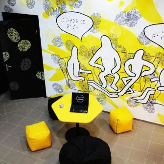 Muzei u Temriavi in Kyiv - creative lounge space with a yellow hexagonal table
