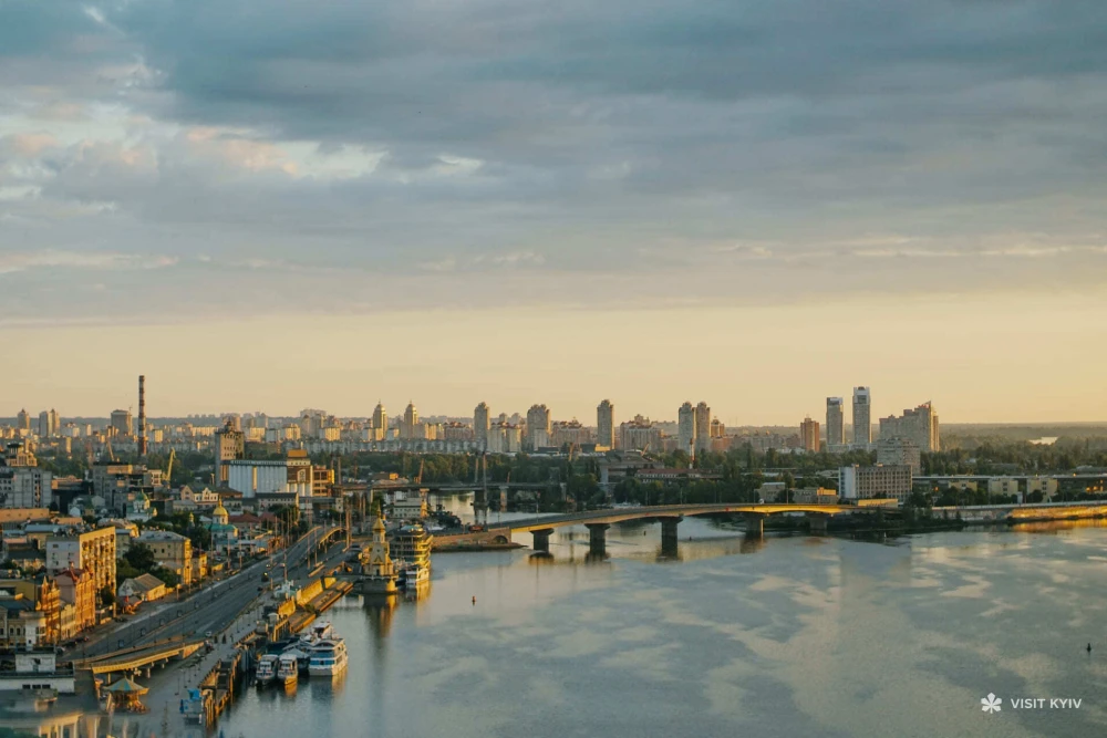 Dnipro river - sunset view of Havanskyi Bridge and Podil embankment