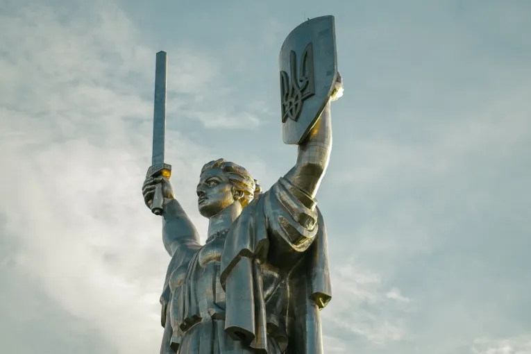 Motherland Monument in Kyiv - close-up of the statue's face and Trident shield