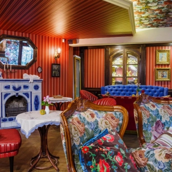 Restaurant Za Dvoma Zaicyamy - dining room with varied seating a sofa and a decorative fireplace