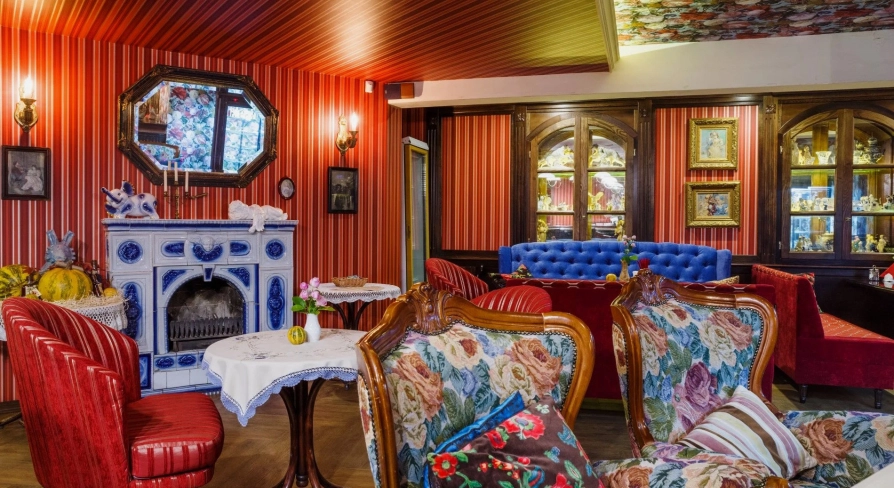 Restaurant Za Dvoma Zaicyamy - dining room with varied seating a sofa and a decorative fireplace