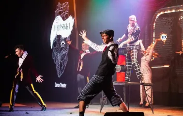 Freedom Hall in Kyiv - smiling performer gesturing on stage during a theatrical show