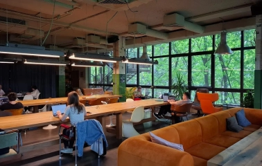Generator - spacious coworking area with long desks, chairs, and good lighting