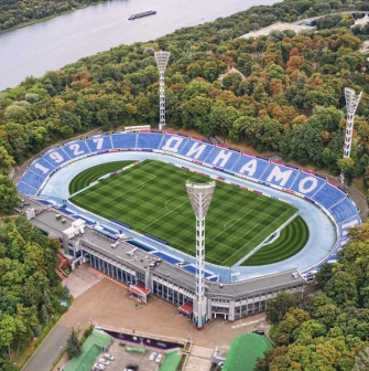 Dynamo Stadium in Kyiv - aerial view of the legendary football arena nestled among the lush green trees of the Mariinskyi Park near the Dnipro river