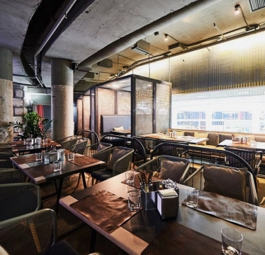 Restaurant Ostannia Barykada - main dining area with industrial design and banquette seating