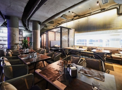 Restaurant Ostannia Barykada - main dining area with industrial design and banquette seating
