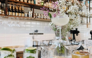 Milk Bar Tsum - close-up view of two tacos with savory fillings and garnish