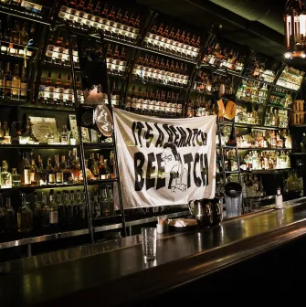 BarmanDictat - bar counter lined with rows of drinks