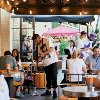 Fish Fetish - outdoor terrace seating area with wooden tables and chairs