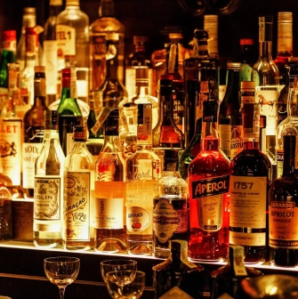 Hendricks Bar - close-up view of three brightly colored cocktails on the counter