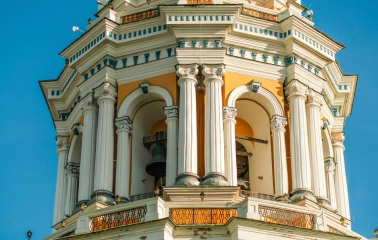Kyiv Pechersk Lavra - the Great Lavra Bell Tower with white columns and a visible bell inside