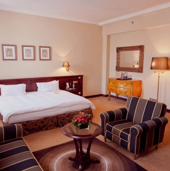 Opera Hotel - comfortable bed in a beautifully decorated room with dark wood