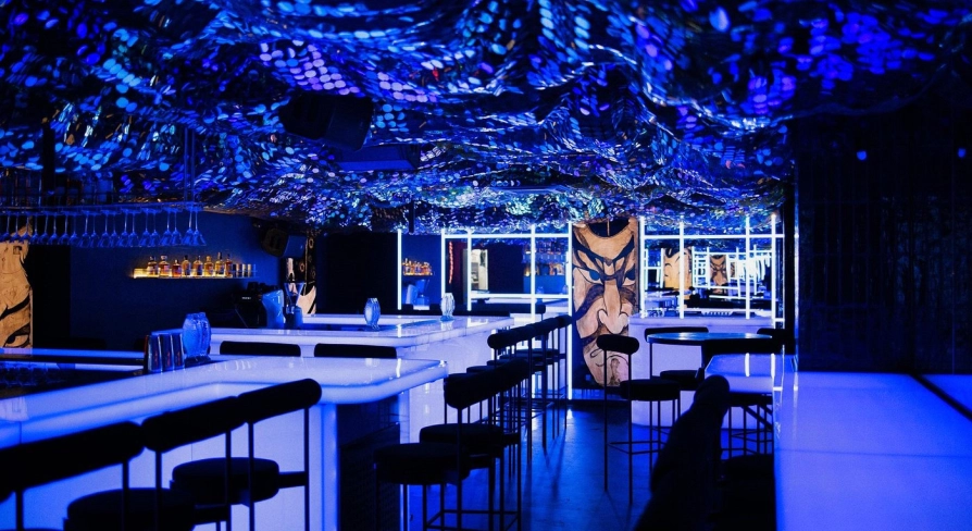 Sansara - stylish interior with mirrored walls and low hanging light fixtures