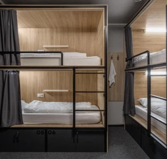 Bunk beds with lighting and curtains at Kyiv Hostel in Kyiv