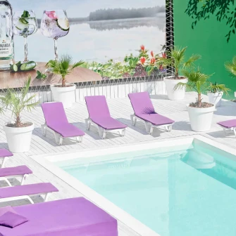 Sun loungers with purple mattresses by the pool at Sungrilla Beach
