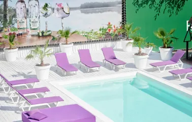 Sun loungers with purple mattresses by the pool at Sungrilla Beach