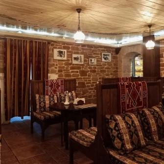 Sofra in Kyiv - dining room with wooden seats, brick walls and traditional design