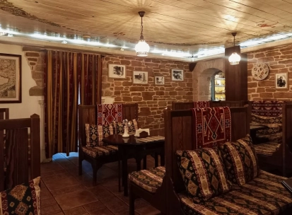 Sofra in Kyiv - dining room with wooden seats, brick walls and traditional design