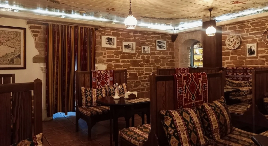 Sofra in Kyiv - dining room with wooden seats, brick walls and traditional design