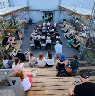 Kooperativ - cozy rooftop coworking area with scattered seating and city view