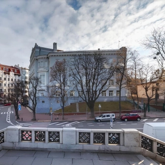 Volodymyrska Street in Kyiv - view of the city intersection framed by vintage street lamps on a stone terrace