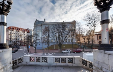 Volodymyrska Street in Kyiv - view of the city intersection framed by vintage street lamps on a stone terrace