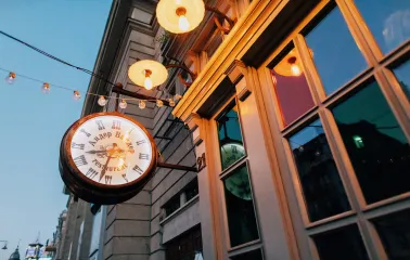 Resraurant Under Wonder - restaurant facade featuring large arched windows and an illuminated clock sign