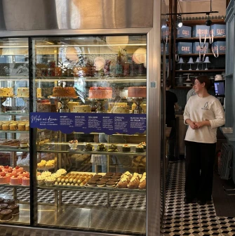 Milk Bar - dessert display with cakes and pastries in glass case