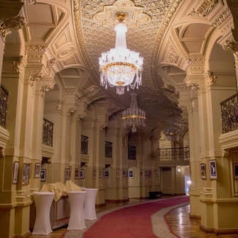 National Opera of Ukraine in Kyiv - luxurious foyer hall filled with golden light from crystal chandeliers and lined with red carpets
