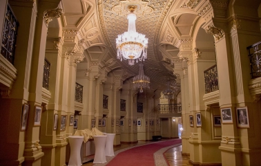 National Opera of Ukraine in Kyiv - luxurious foyer hall filled with golden light from crystal chandeliers and lined with red carpets
