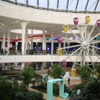 Indoor Ferris wheel inside the Respublika Park shopping center among green areas